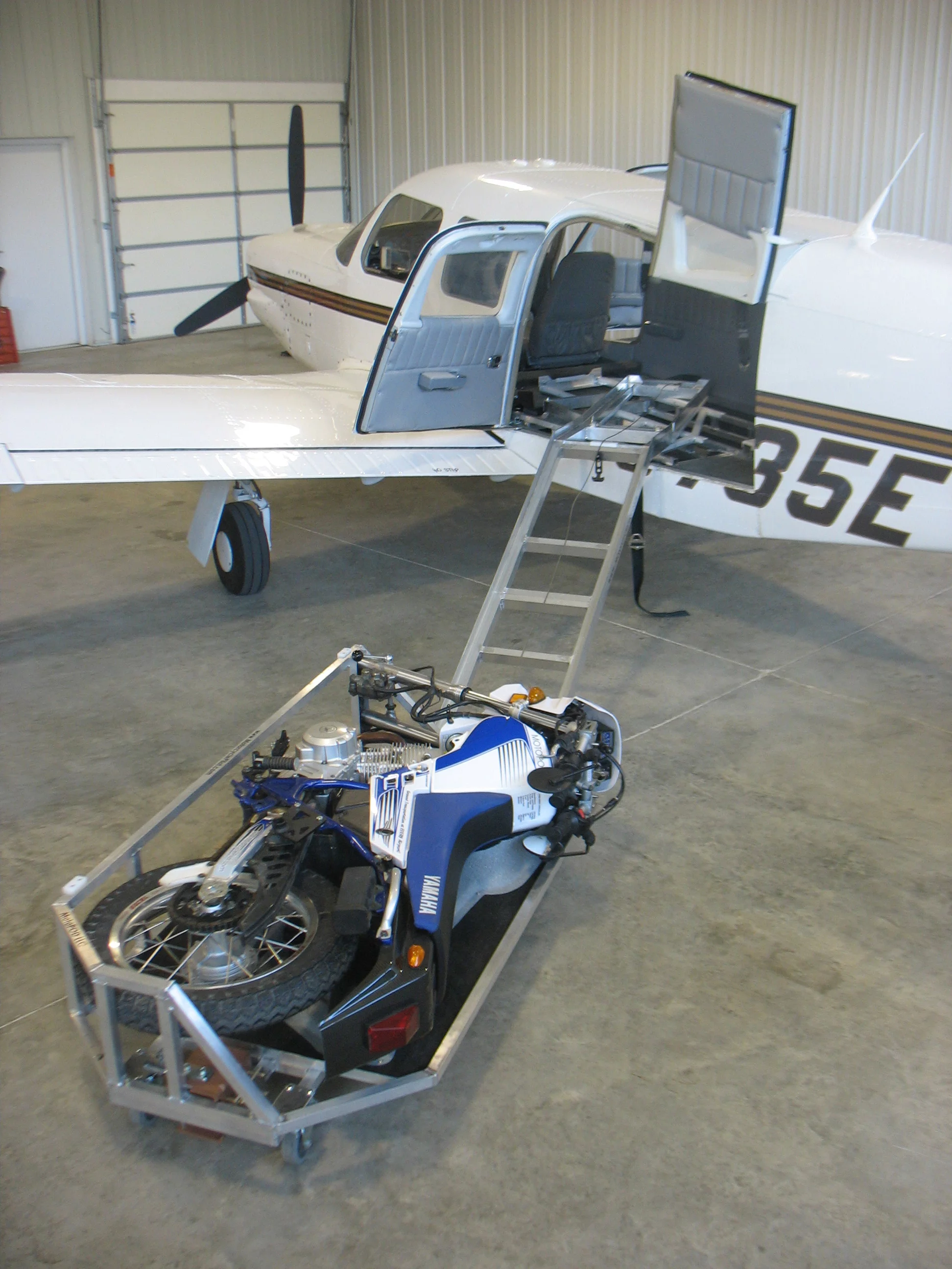 The MotoLOAD consists of a sled into which a MotoCYCLE is laid and winched into the airplane