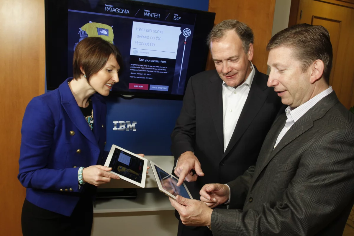 IBM executives explore Watson apps, with a shopping portal powered by Watson in the background (Photo: Jack Plunkett, Feature Photo Service)