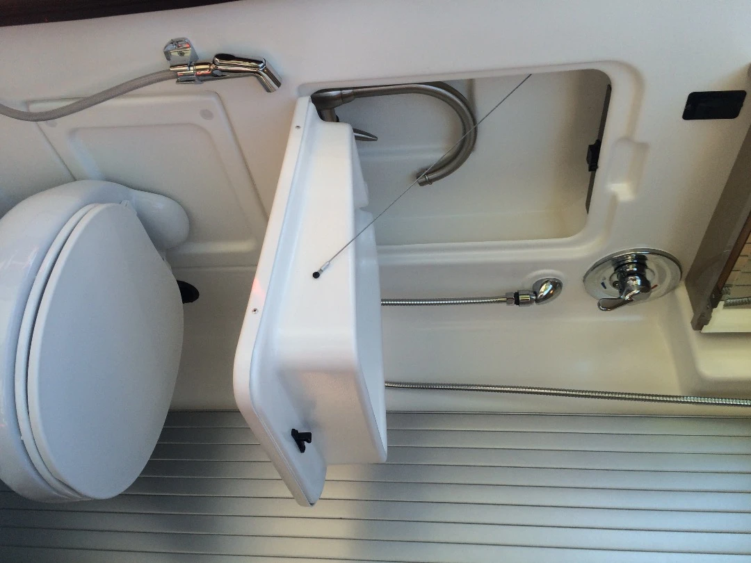 The Travato 59K floor plan includes a rear bathroom with toilet, shower and drop-down sink