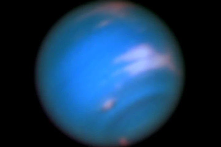 The dark spots are vortices in the atmosphere of Neptune
