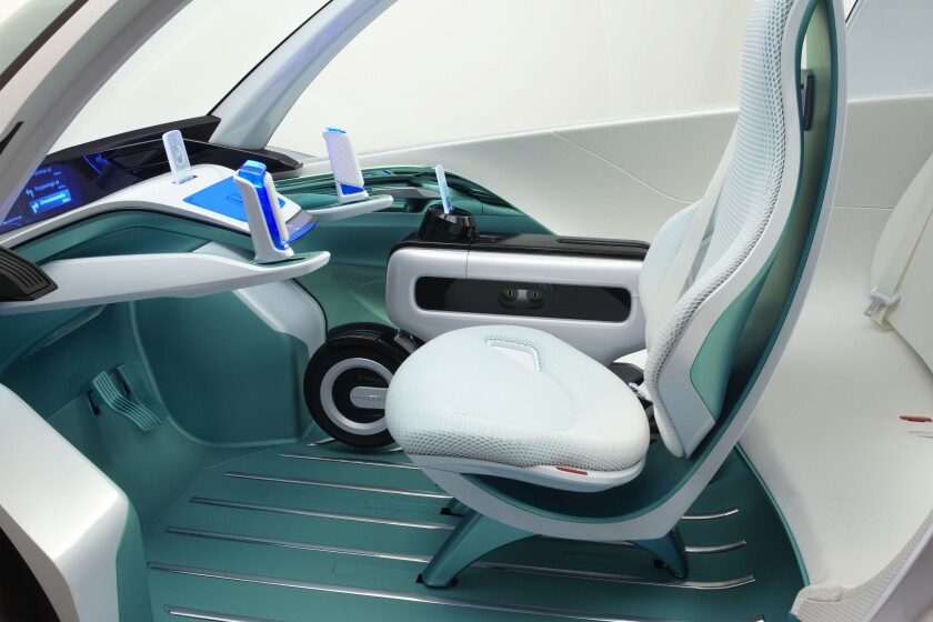 An interior view of the Micro Commuter Concept shows the Motor Compo stowed next to the driver.