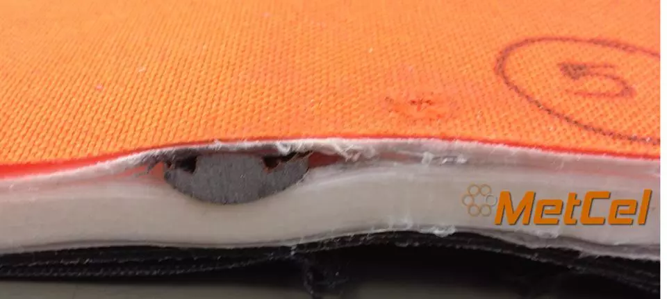 Close-up of a 9mm bullet caught in the layers of the Bodyguard Blanket