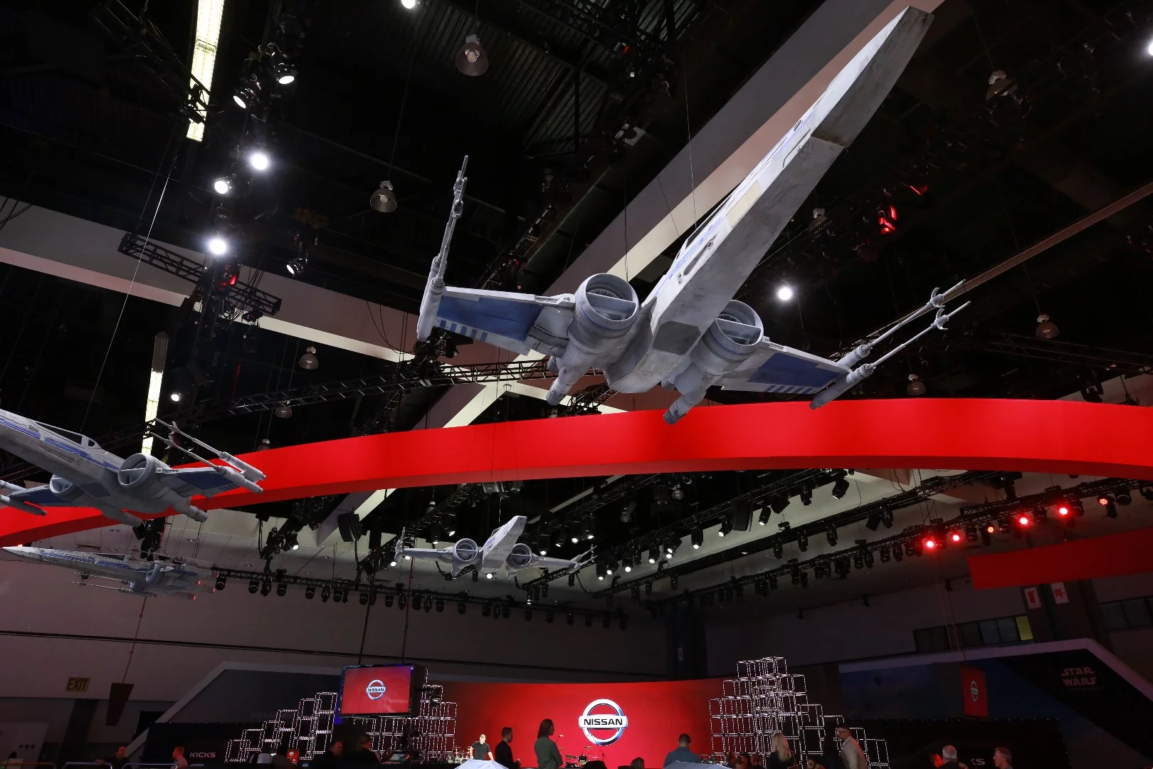 X-wing fighters hang over the Nissan stand at the LA Auto Show