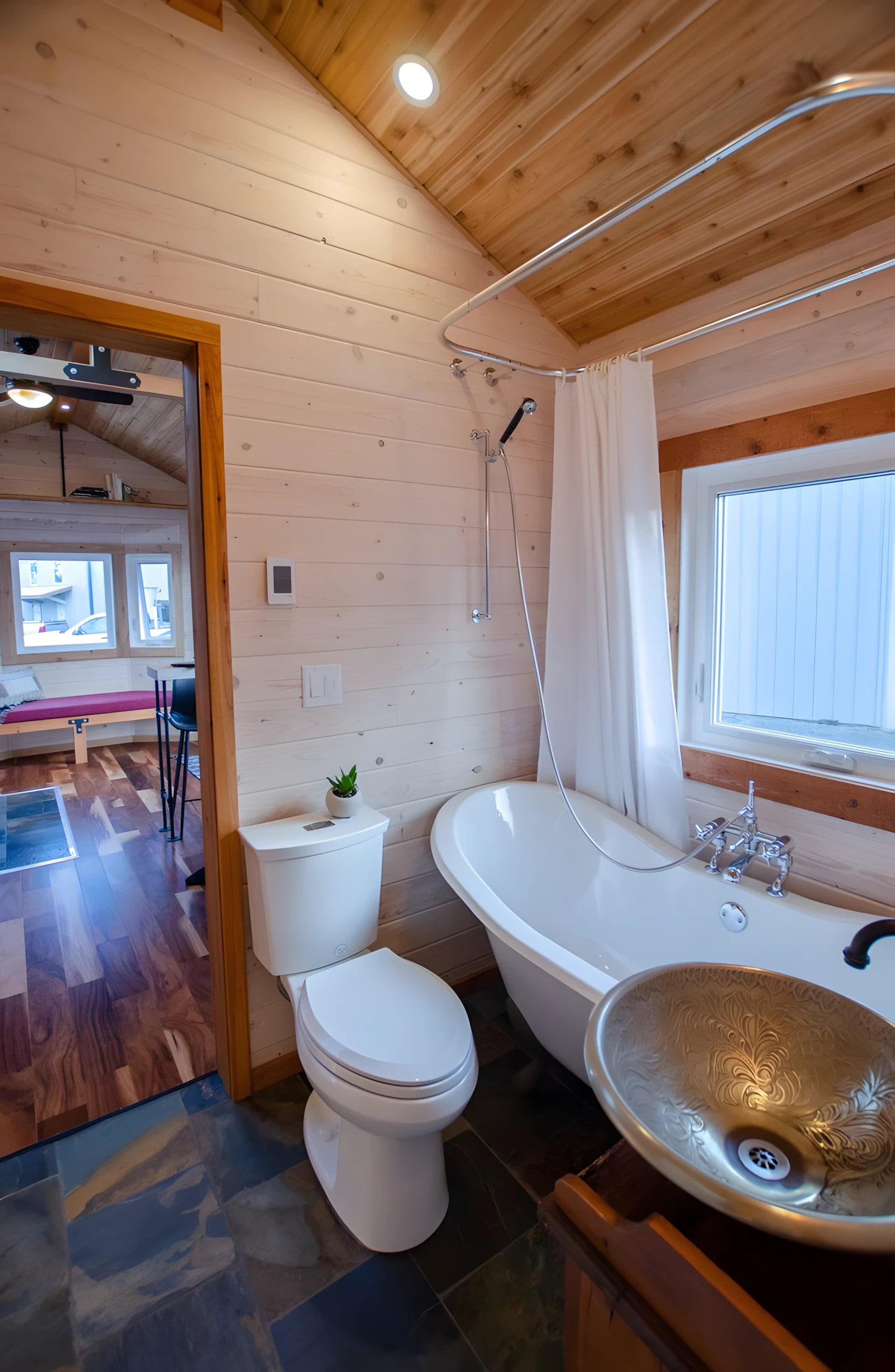 The Huckleberry's bathroom includes a flushing toilet, a sink, and a stacked washer/dryer
