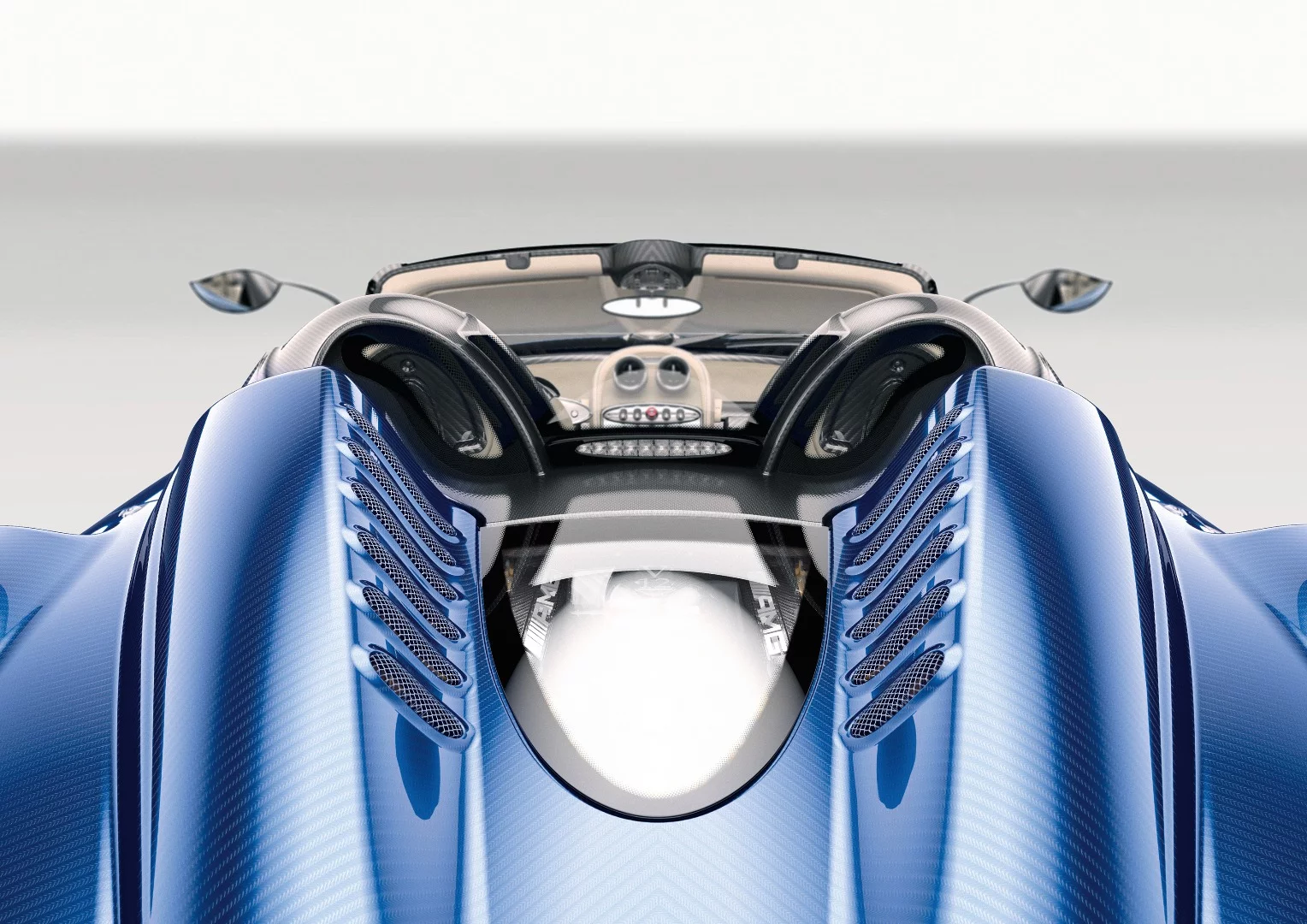 The V12 engine in the Huayra is barely contained by the glass cover