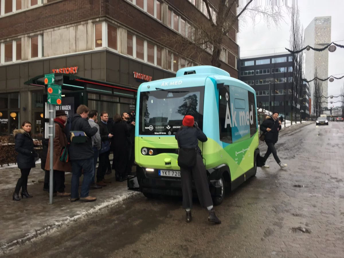 Some of the first passengers about to board one of the self-driving shuttle buses