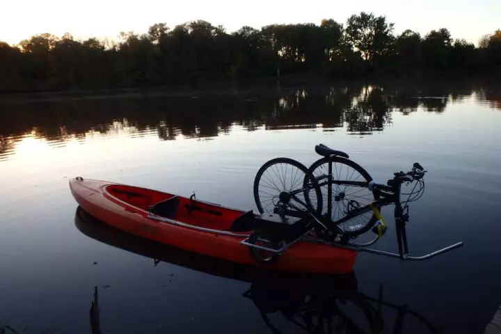 The Solo Shuttle Trailer lets you tow your kayak behind your bike, then mount your bike on your kayak