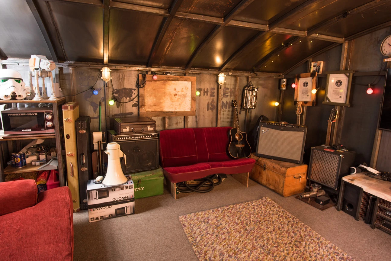 Inside the bunker part of the Colin Furze Secret Bunker are consoles, a drum kit, and more