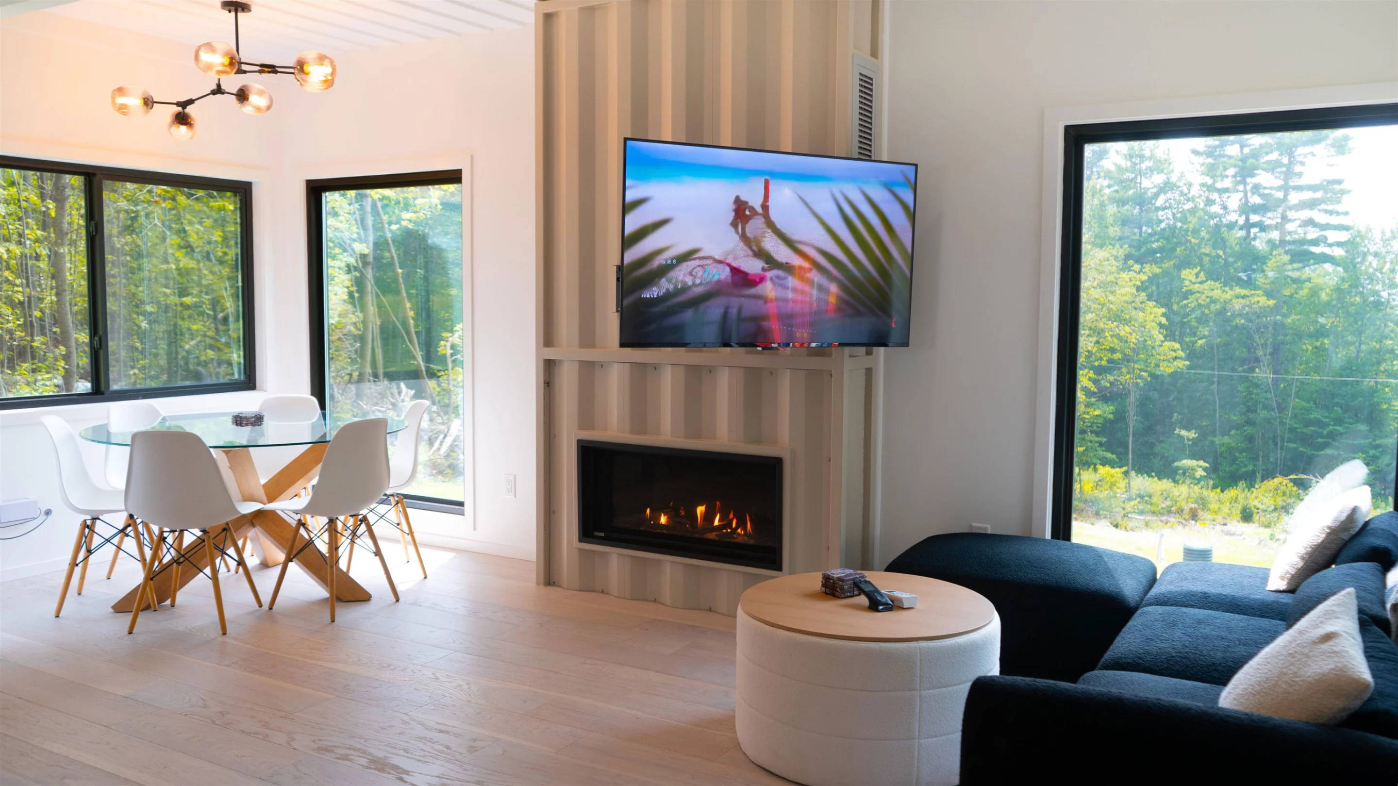 The Vermont Villa includes a main living room with a large sofa, a wall-mounted TV, and an electric fireplace