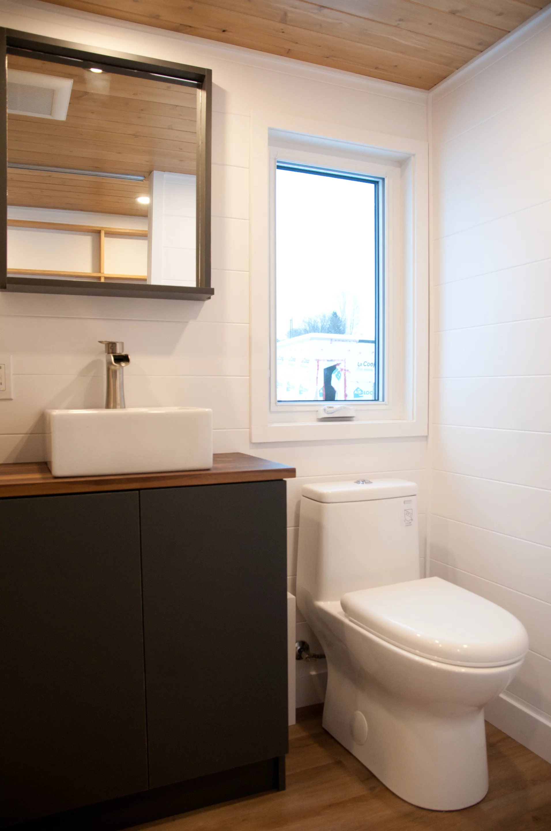 The Noyer XL's bathroom includes a shower, vanity sink, and a flushing toilet, as well as some storage space