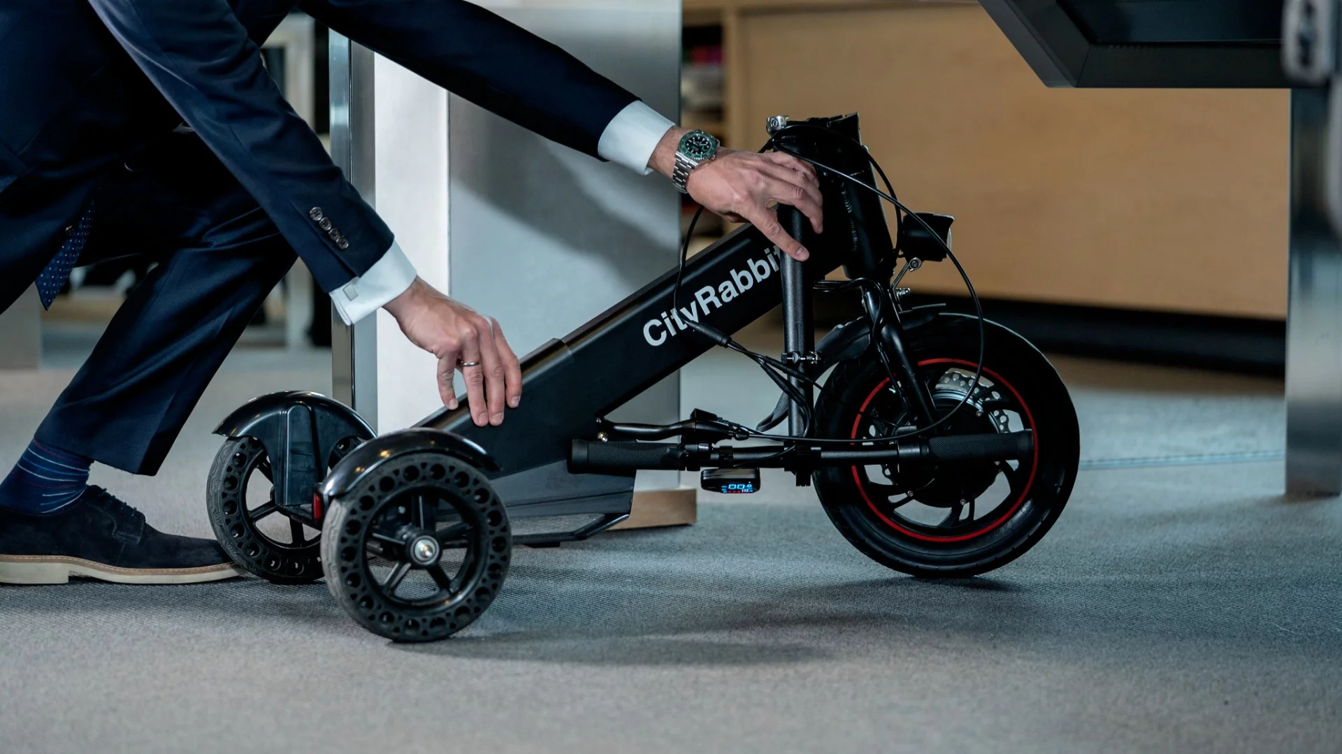 The CityRabbit's adjustable-height handlebars can be quickly folded down with one hand, when it's time to take it on the bus or stow it in the office