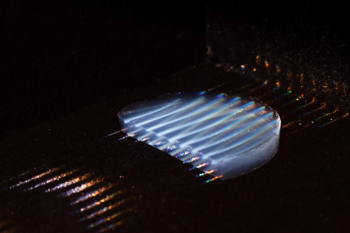A sample of the aerogel, with parallel laser beams running through it to make it visible for the photo