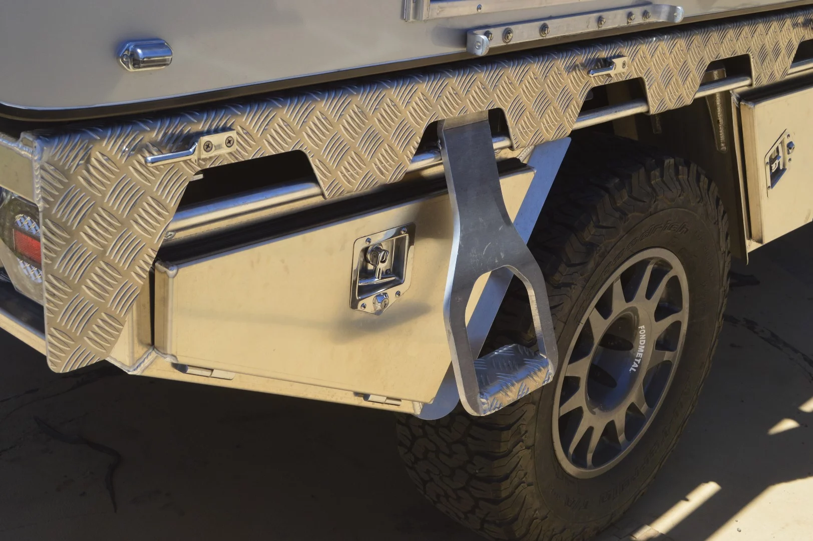 The step for the Four Wheels Campers Woolrich Edition looks a bit like a large bottle opener