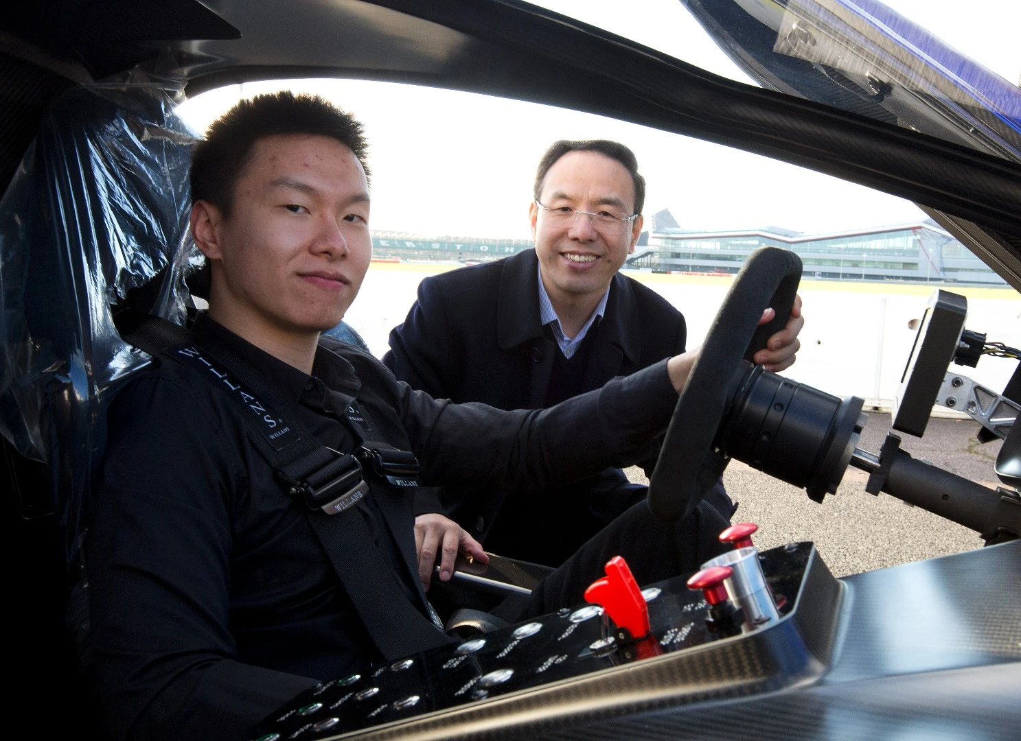 Techrules CTO Matthew Jin poses at the wheel of the AT96 with William Jin, founder and CEO, outside
