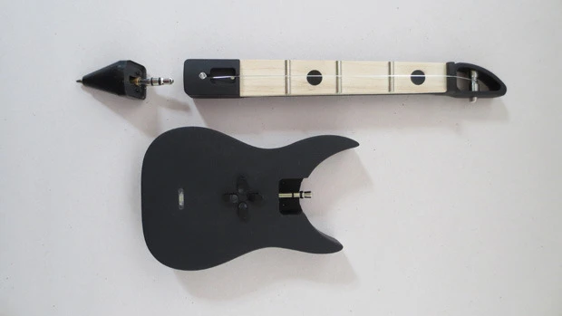 The FretPen hardware comprises a pen tip, a guitar-shaped body housing electronics and battery, and a sensor-packing neck with one string over three frets