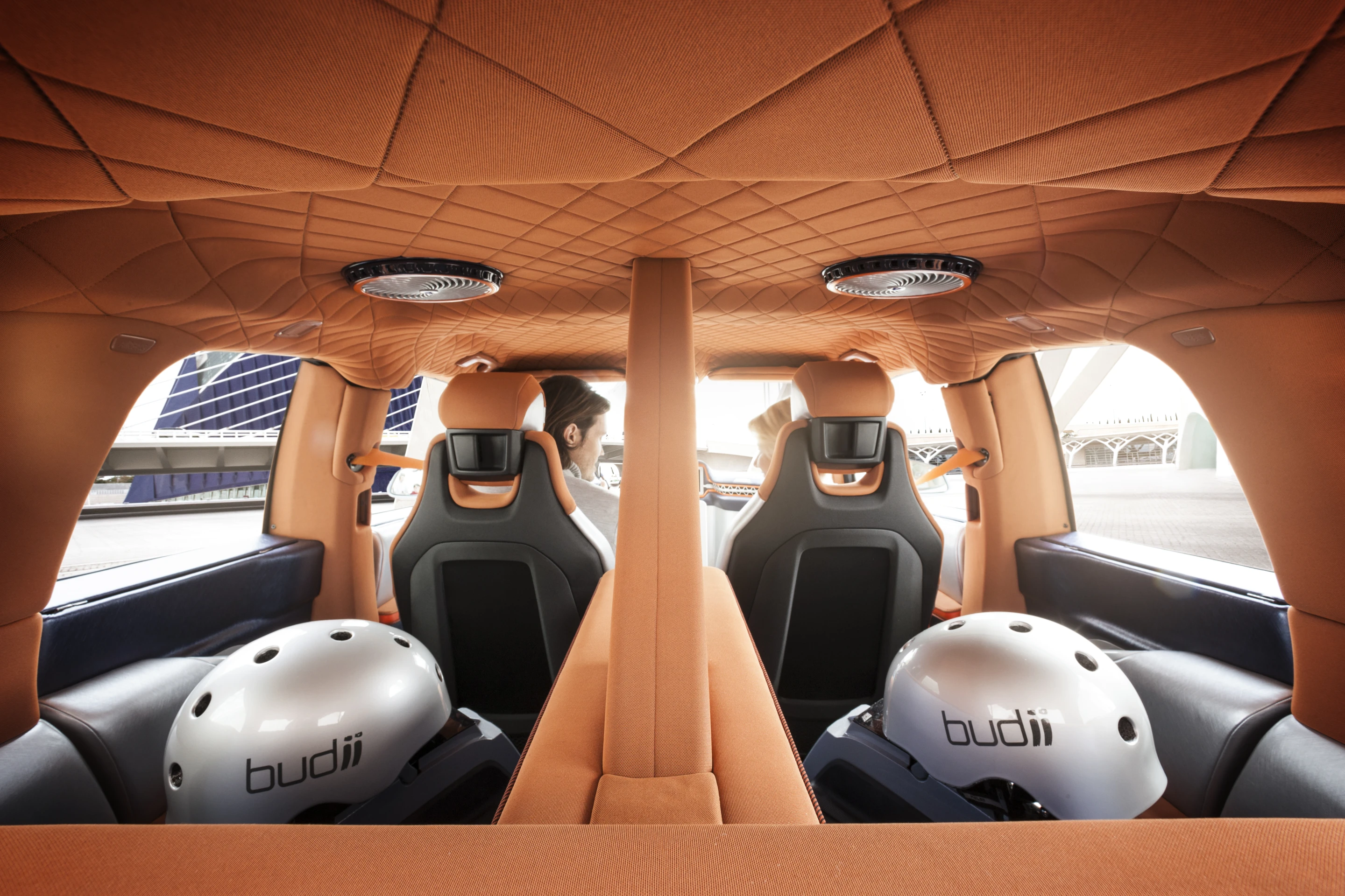 Two electric mini vehicles that are housed in roll-out draw pods on either side of the car
