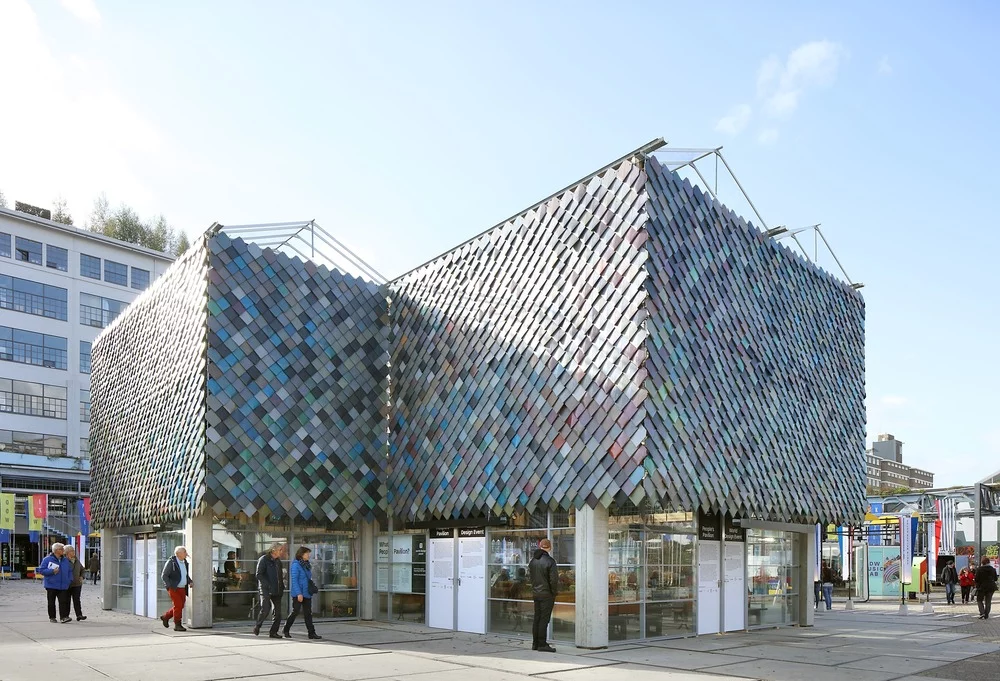 The People's Pavilion's upper facade comprises colored plastic tiles made by recycling household waste