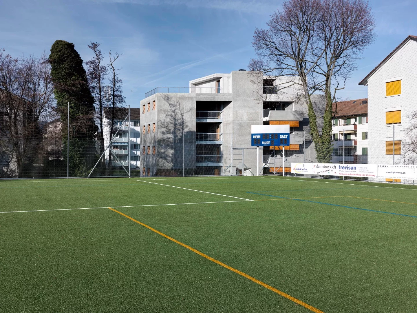 Affordable Housing Langgrütstrasse overlooks a sports field