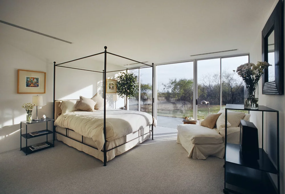 Large glass windows at the back of the house offer expansive views