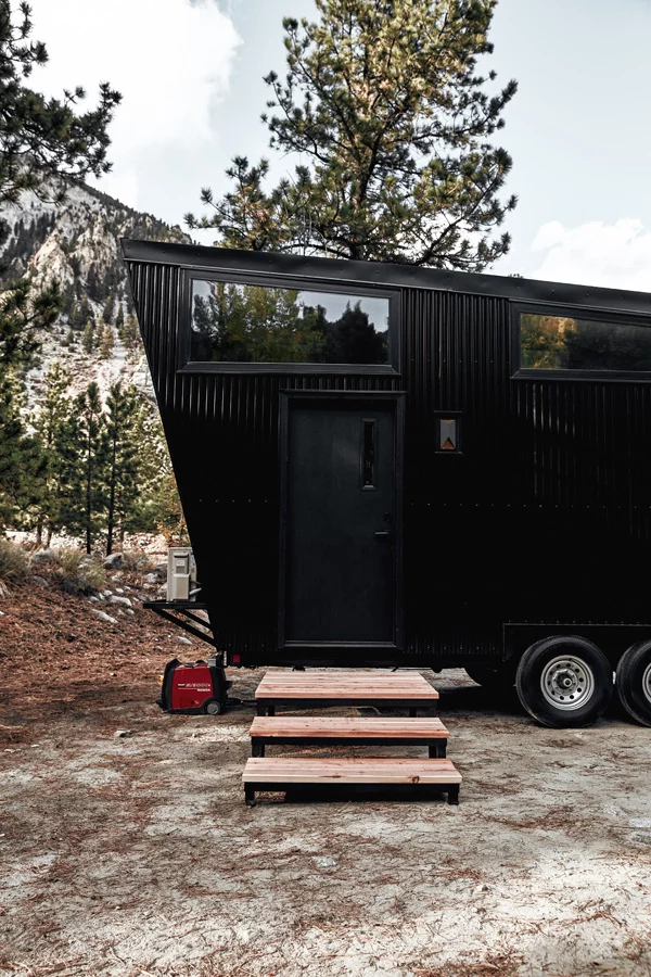 The Draper is finished in black corrugated metal siding with wood accenting