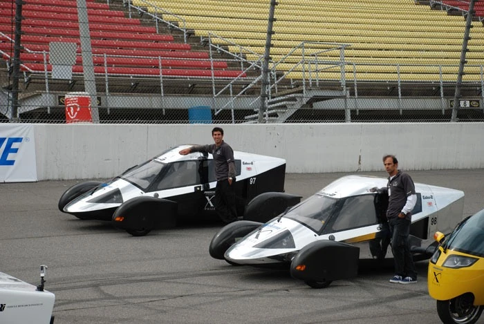 The Automotive X-PRIZE-winning Very Light Car #98 (right) at the Finals stage