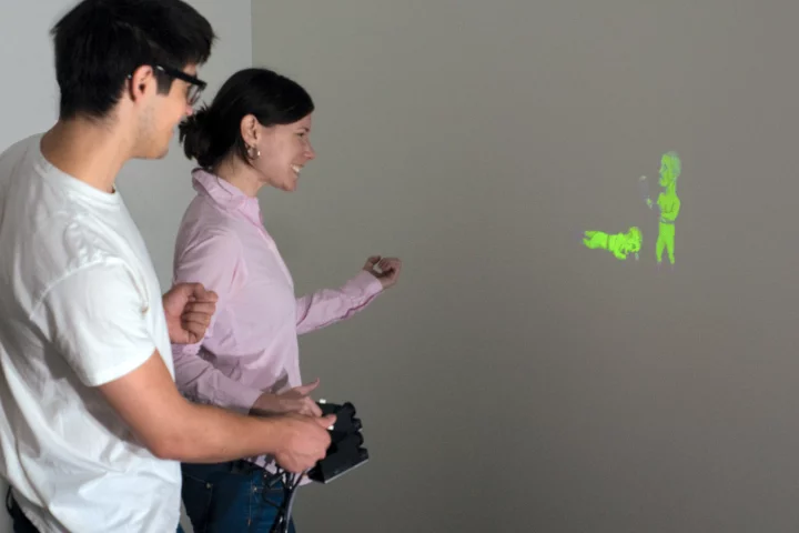 The prototype SidebySide system allows animated images from two separate pico projectors to interact with one another (Photo: Disney Research)