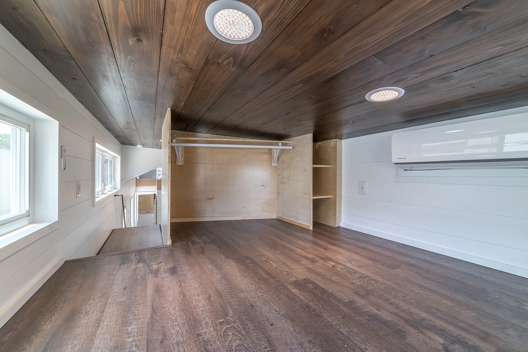 The front loft (above the covered porch) is big enough for a queen size bed but with a low ceiling. It has its own climate control as well