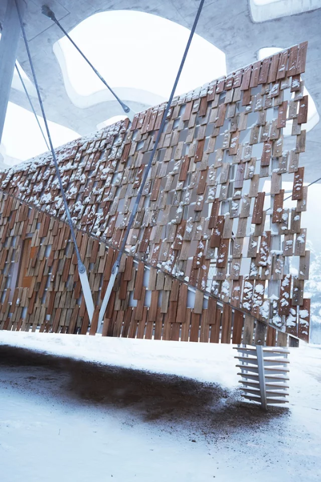 The dwelling features a natural timber facade, made from a series of locally sourced oak and larch panels