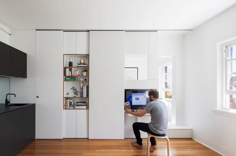 The 27-square meter (290-sq ft) apartment was transformed into a multi-functional home that comfortably accommodates two