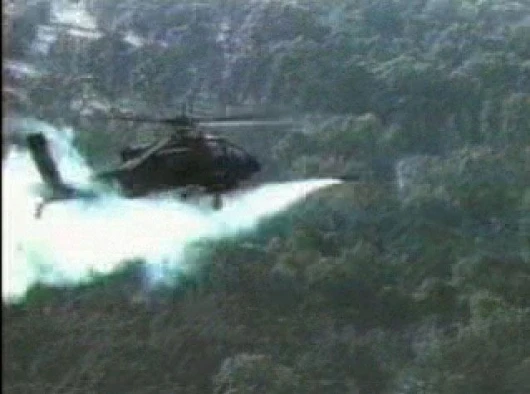 An Apache helicopter launches a Hellfire II missile which is then tracked into the distance where it successfully targets an armoured vehicle. Click on the image for a preview, click