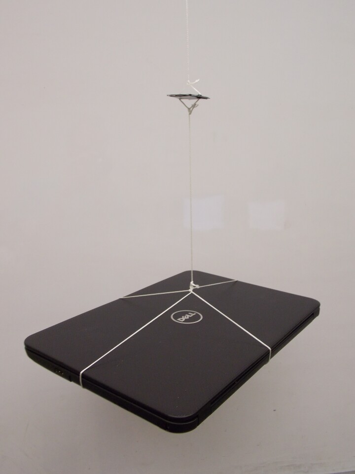The engineers suspended a heavy laptop from the supercapacitor to demonstrate its strength (Photo: Vanderbilt Nanomaterials and Energy Devices Laboratory)