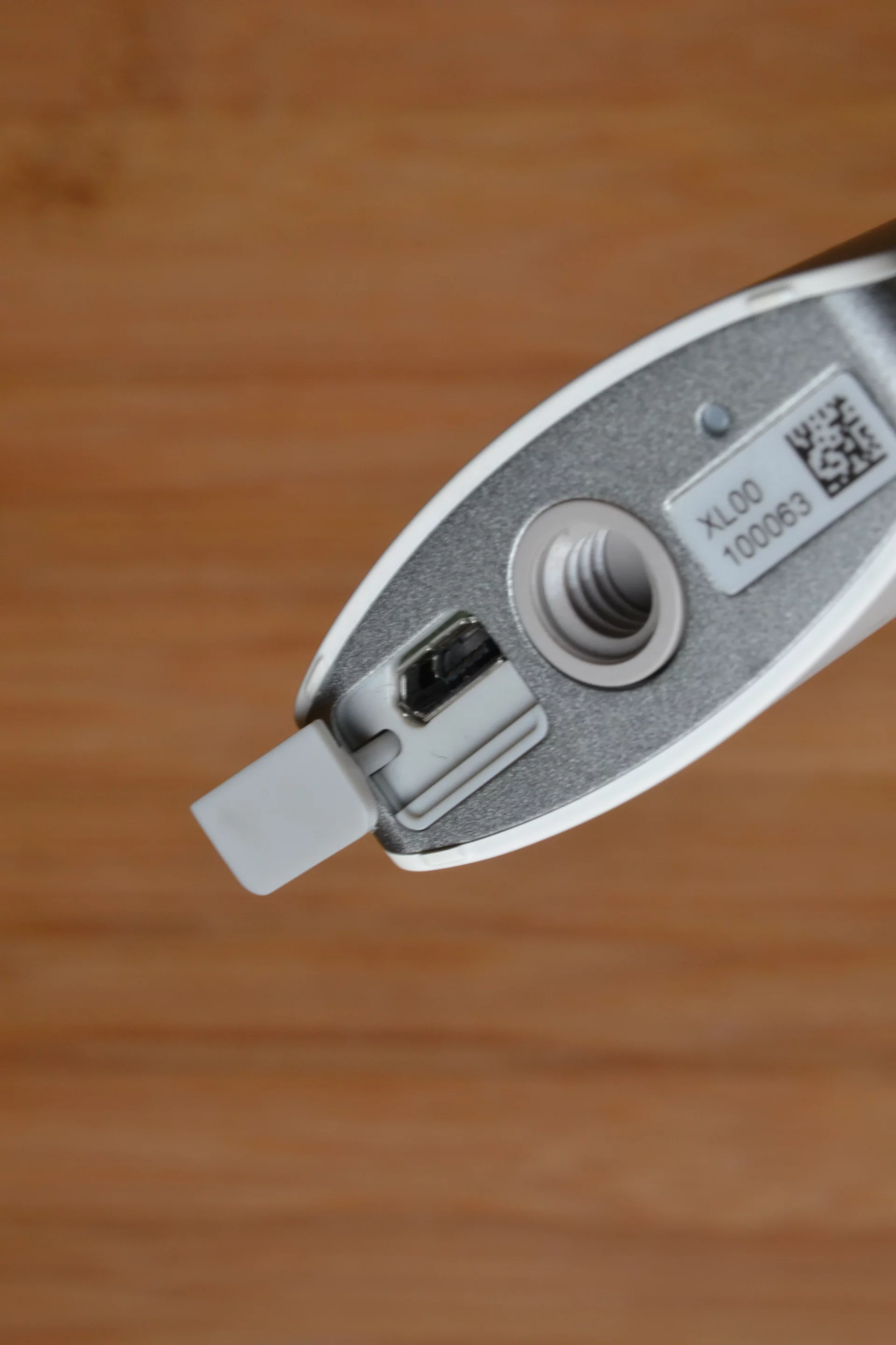 There's a covered USB port at the bottom for charging the Theta's Li-ion battery, and for connecting the camera to a computer