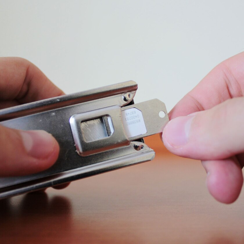 A micro-SIM card being placed into the Nano SIM Cutter for trimming