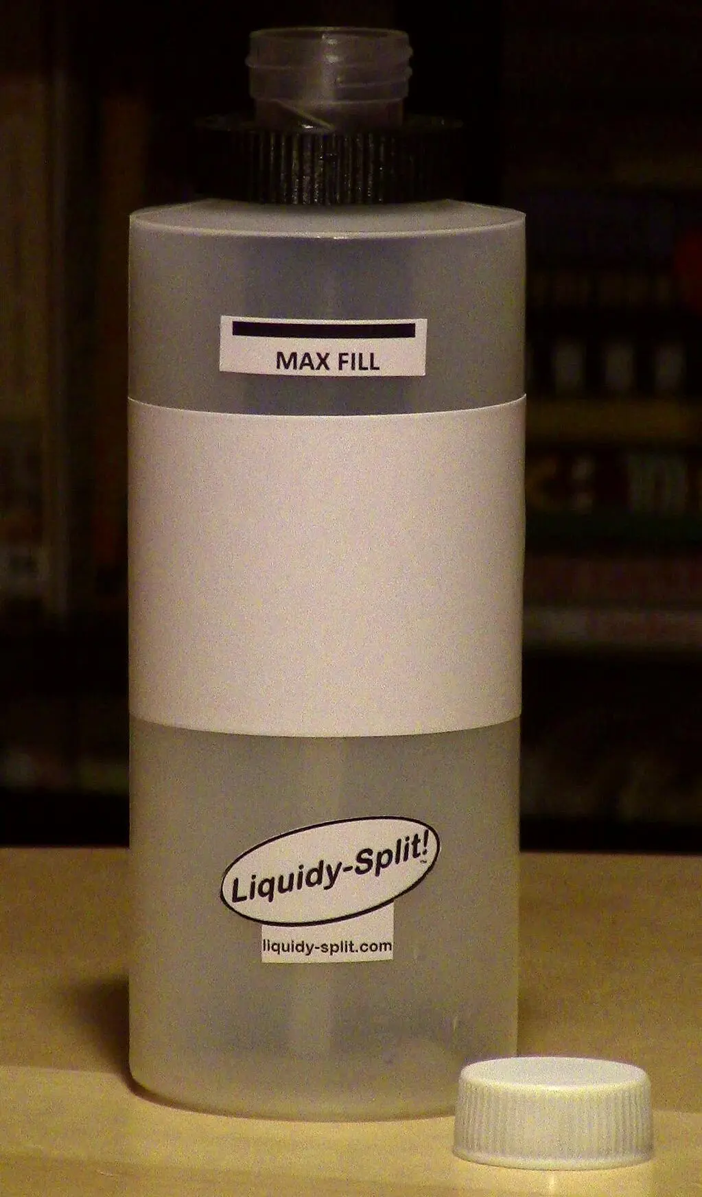 Rather than a normal spout or opening, the bottle has a measuring receptacle on its top