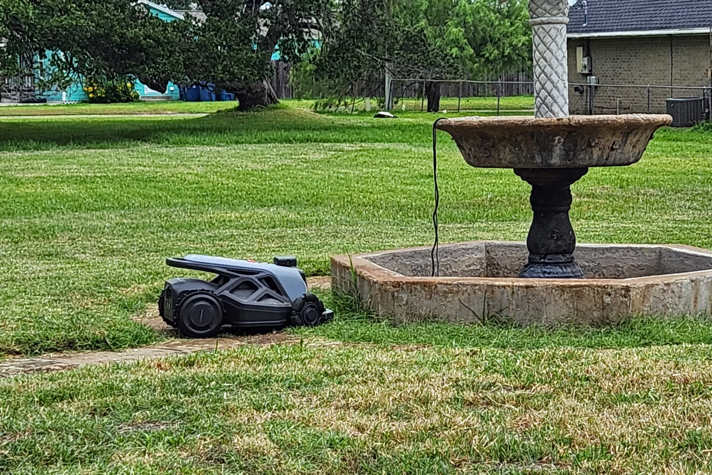 I kid you not, twice in a row, the Tron ended up in this exact same spot, both times having crashed into the fountain repeatedly before it simply shut down. On the plus side, the Tron is physically bigger than all the other mowers I've testedd, it's hands down the EASIEST robomower to carry, as it has a huge handle on the back, and a decently big one on the front.