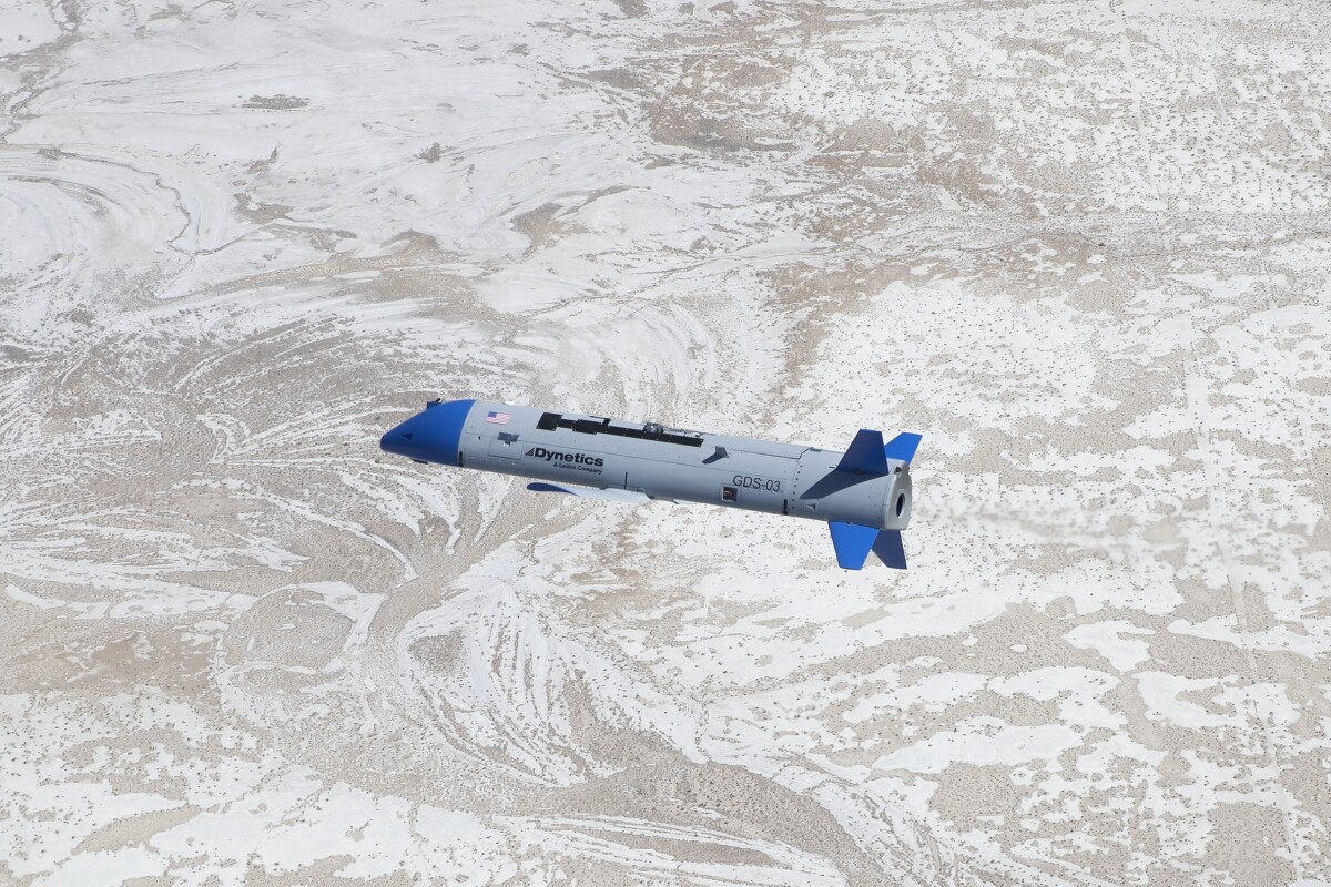 The X-61A vehicle in flight below an Air Force C-130