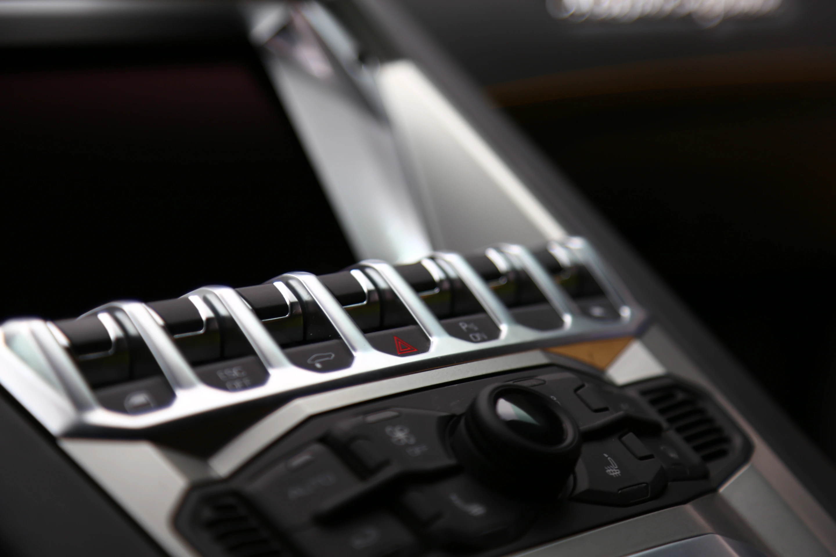 The console mounted switch panel includes a suspension raising switch to help the Aventador clear speed bumps and the like (Photo: Angus MacKenzie/Gizmag.com)