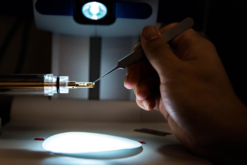 A sample of the aluminum alloy being prepped for analysis by a transmission electron microscope, to study its crystal structure