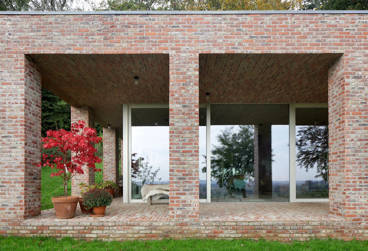 Sloped Villa boasts a large exposed-brick exterior terrace