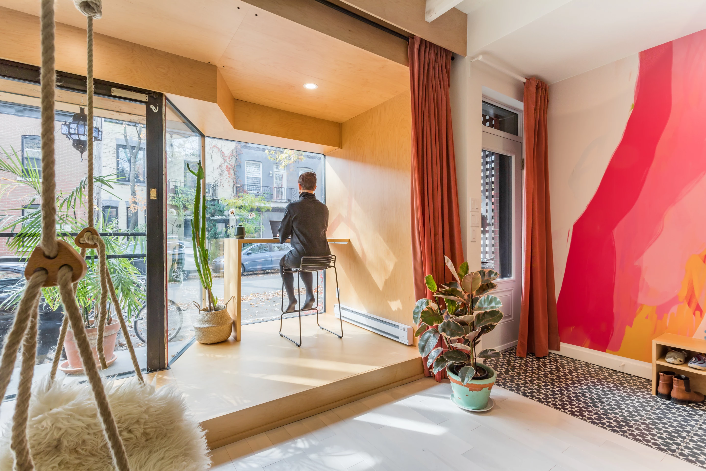 Atelier Chabot's main living area includes a small home office with a desk and stool seating