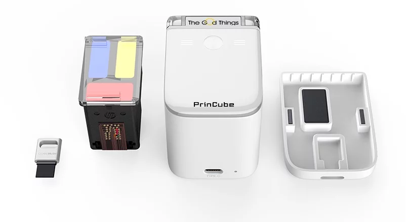 The PrinCube with its cartridge, cover and cleaning brush