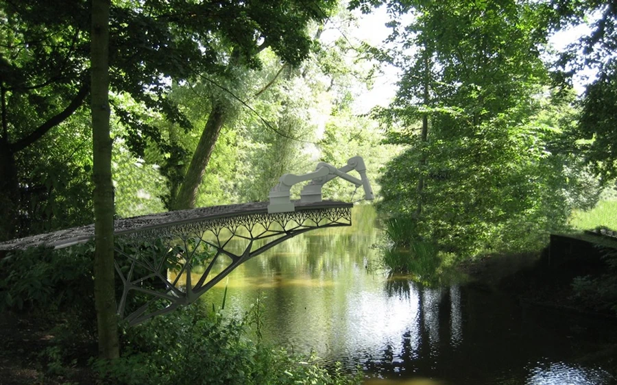 The robots will begin printing the bridge on one side of the canal and will create rail-supports as they go