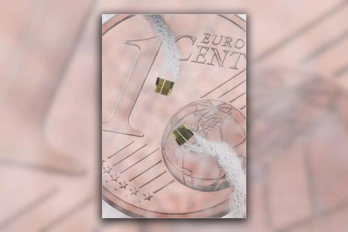 A pair of the microbots maneuver in liquid on top of a 1 cent euro coin