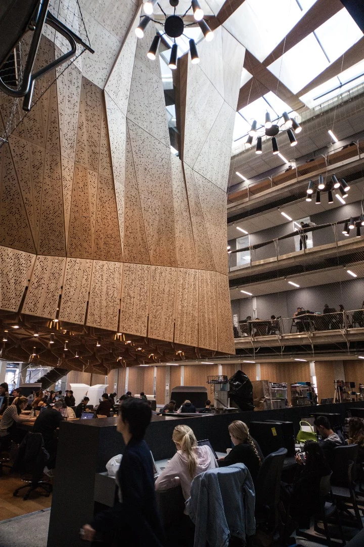 The building's centerpiece is a stalactite-like structure that houses three studio spaces stacked on top of one another