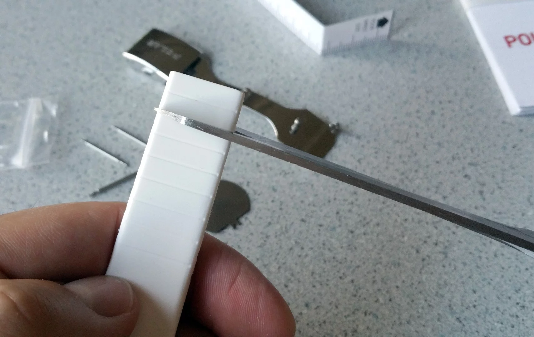 While you could use scissors as the instructions suggest, it's better to trim the Loop 2 band with a sharp knife