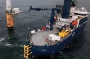 An electric service boat uses an experimental version of the new system, powered by a wind turbine