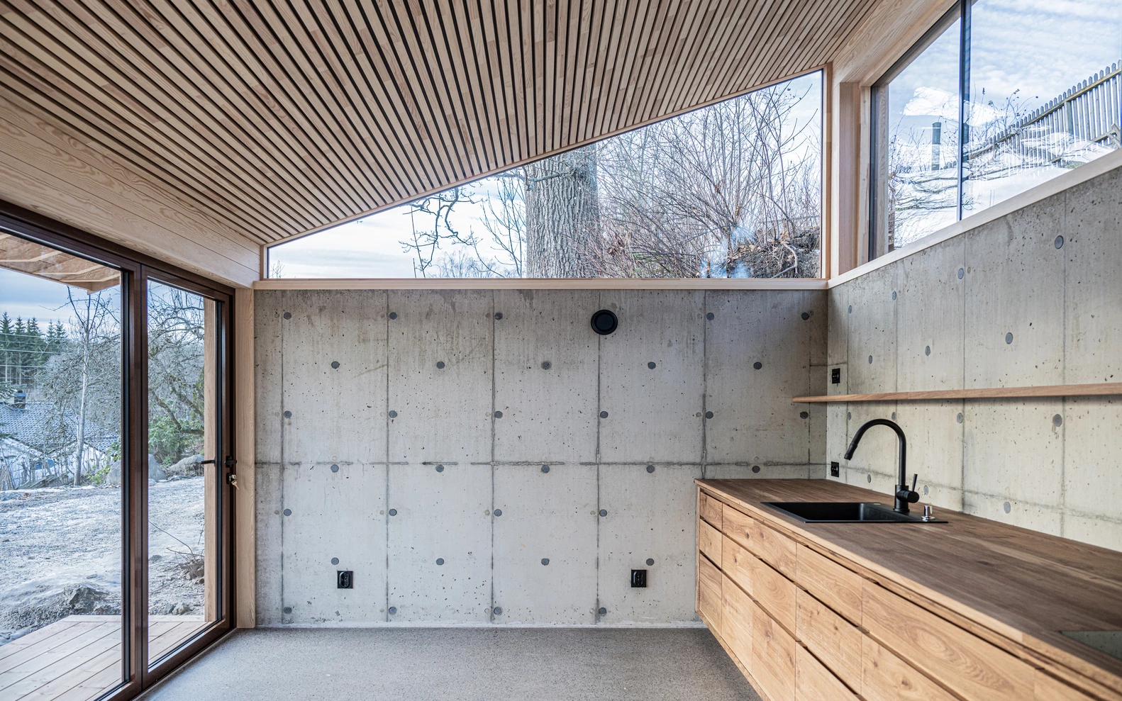 Sunlight pours through the glass façade, illuminating the dining area