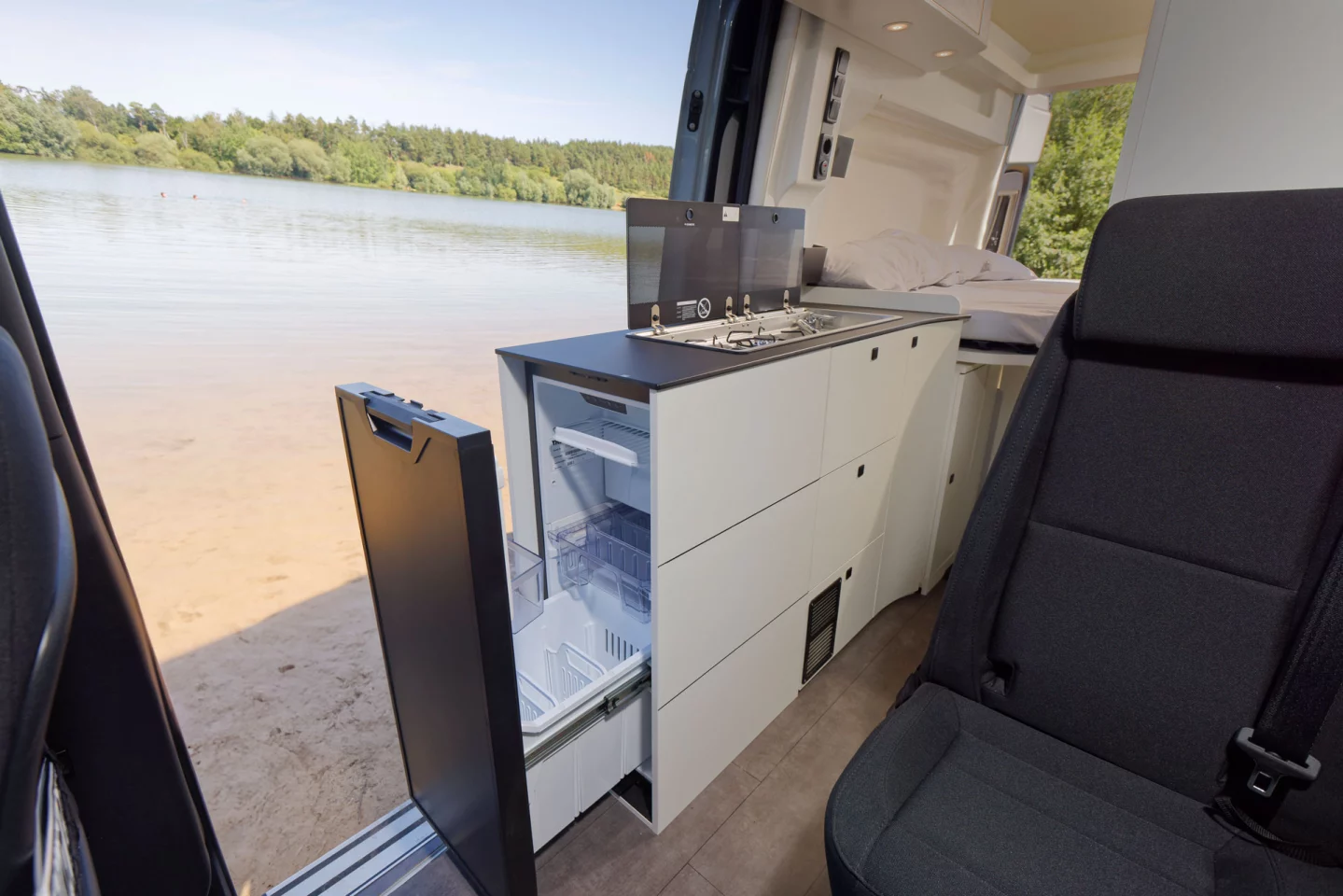 Kitchen block with indoor/outdoor-access drawer-style fridge