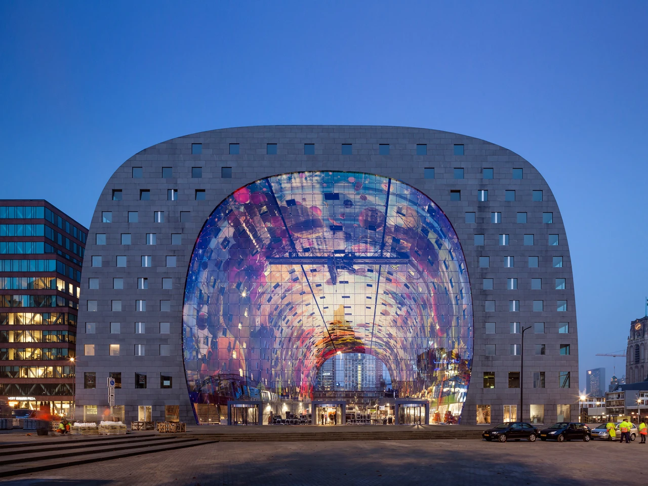 Rotterdam's new market hall, Markthal, is a huge arch that houses residential apartments