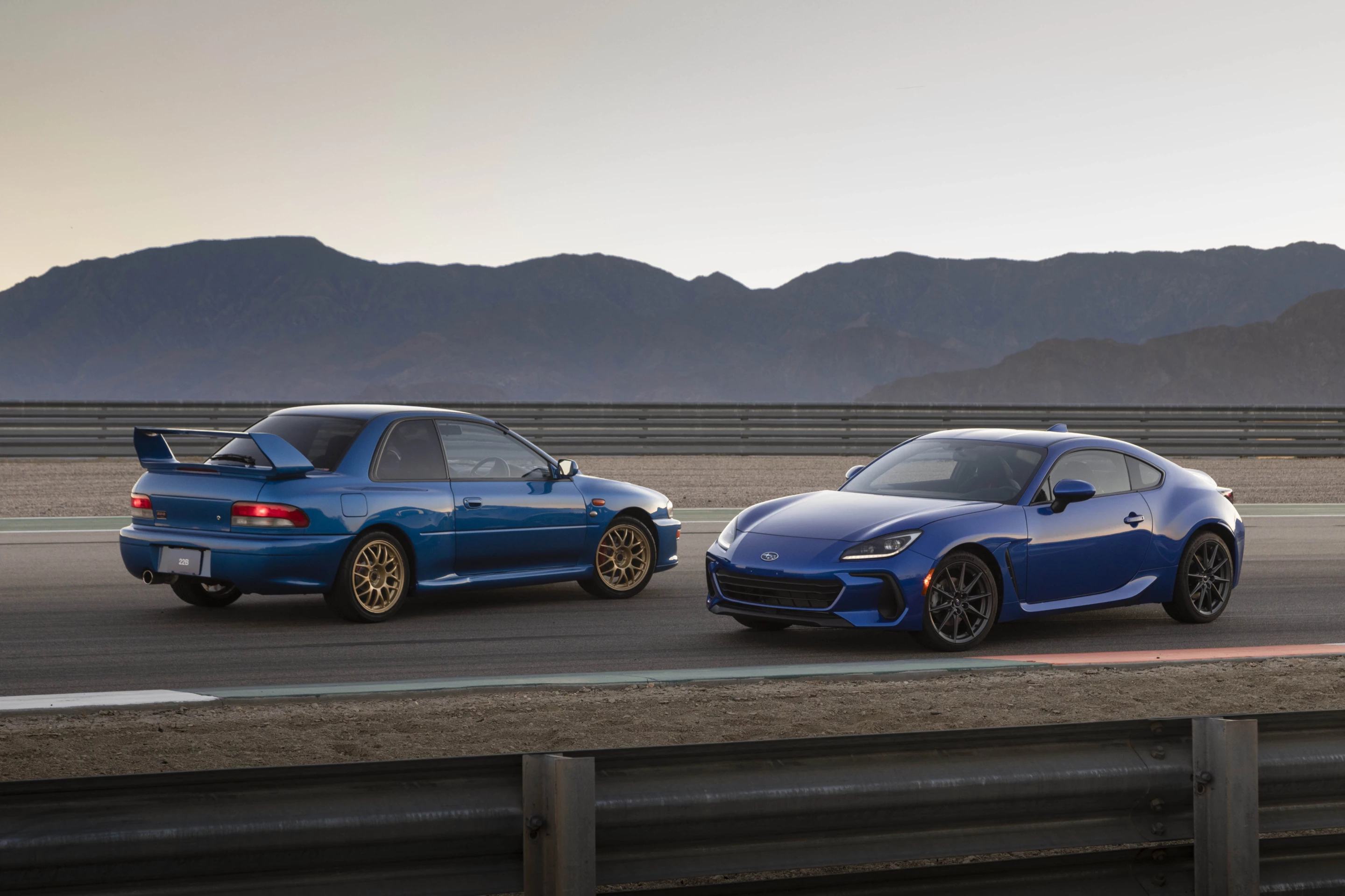 In a photo nod back to its heritage, the 2022 Subaru BRZ is shown (right) alongside an Impreza WRX STi 22B, the road-going version of one of Subaru's Impreza 555, the company's most-loved heritage sports model